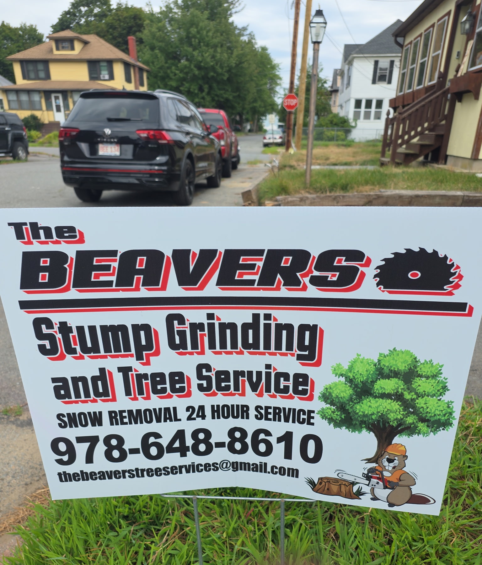 The Beavers Stump Grinding and Tree Service yard sign, listing snow removal, 24 hour service, and phone number 978-648-8610